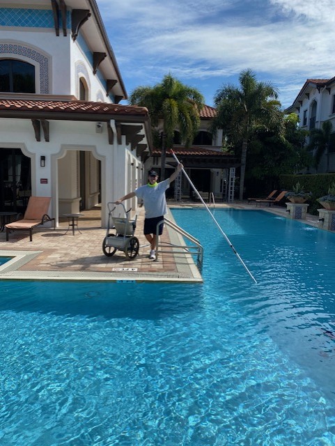 Better Pool & Spa technician cleaning a residential swimming pool in South Florida